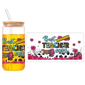 Detail view of teacher theme UV DTF wrap on 16oz glass can with bamboo lid and straw