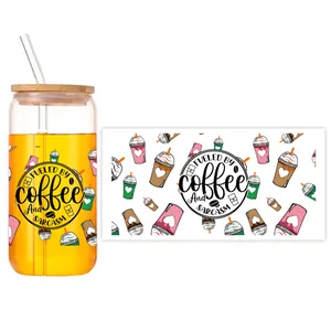 Flat lay of UV DTF transfer decal with coffee theme on 16oz beer can glass with lid