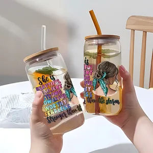 Detailed view of 16oz glass cups with bamboo lids, straws and UV DTF floral transfers