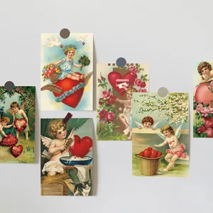 Detail of vintage Cupid Valentine postcards with heart and floral motifs on a wall