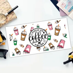 Detail of coffee themed UV DTF sticker with Fueled by Coffee and Sarcasm text on glass