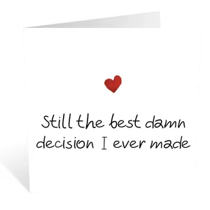 Close-up of a minimalist folding birthday card with a red heart and humorous text