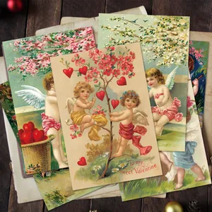 Detail of vintage Valentine postcards featuring Cupid and floral motifs on wood background