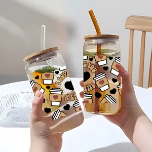 Close-up of 16oz glass cup set with vintage coffee prints, bamboo lids and straws