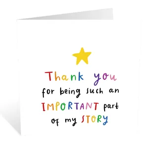 Close-up of minimalist square greeting card with colorful Thank You text and yellow star