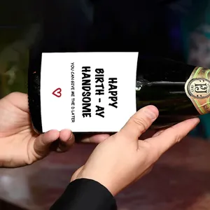 Close-up of a green wine bottle with custom Happy Birthday Handsome creative sticker