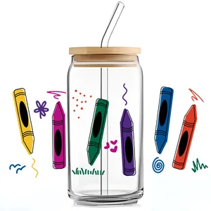 Detail view of colorful crayon UV DTF transfer on a 16oz glass can with bamboo lid