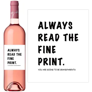 Detail of wine bottle label with 'Always read the fine print' pregnancy surprise message
