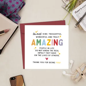 Flat lay of an amazing greeting card set with a red envelope on a beige desk surface