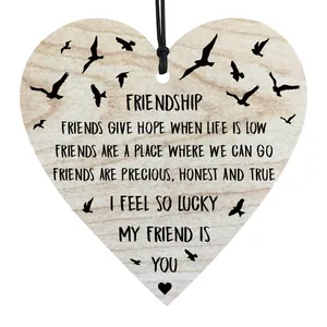 Heart shaped wooden plaque hanging ornament with friendship quote and wood grain texture