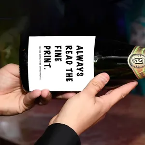 Custom wine bottle label showing pregnancy reveal message on dark glass bottle