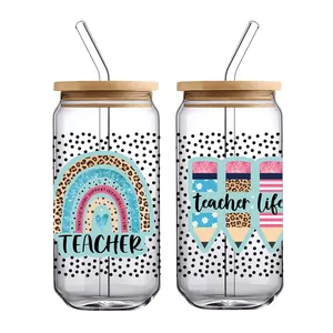 Detail of 16oz glass cups with bamboo lids and teacher-themed UV DTF transfers