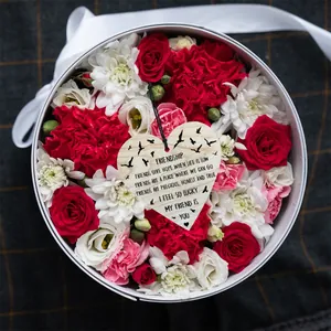 Heart-shaped wooden plaque with friendship poem in a floral gift box centerpiece