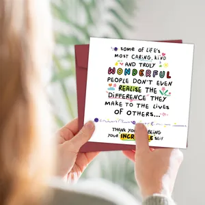 Funny greeting card with creative illustrations and burgundy envelope held in hands