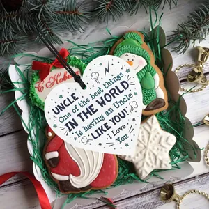 Detail of heart wooden plaque gift for uncle with ribbon and festive decorations