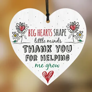 Close-up of heart wooden plaque with BIG HEARTS SHAPE little minds inspirational text