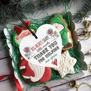 Detail of heart-shaped wooden gift tag with floral print in a festive holiday box
