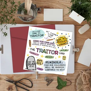 Close-up of funny traitor-themed farewell card with red envelope on a wooden desk