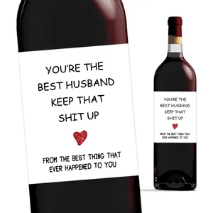 Close-up of creative wine bottle sticker with humorous text and red heart graphic