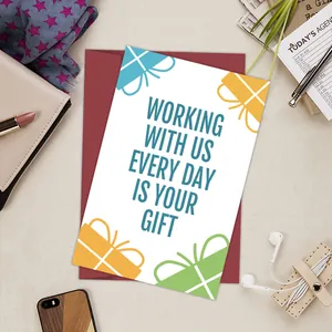 Close-up of funny office birthday card with a dark red envelope on a tidy desk