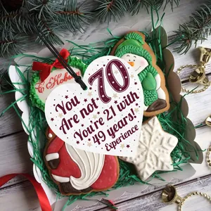 Close-up of heart-shaped wood sign for 70th birthday celebration in gift box