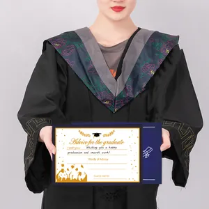 Detail of 2025 graduation advice card with gold text held by a student in a black gown