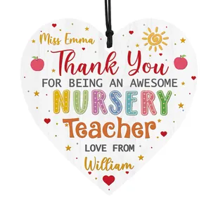 Close-up of heart-shaped wooden nursery teacher thank you plaque with hanging rope