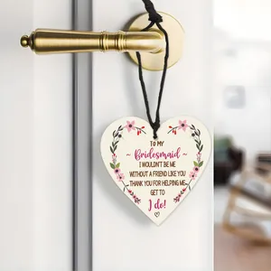 Detail view of heart-shaped wooden bridesmaid thank you tag hanging on door handle
