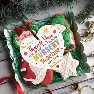Detail of heart-shaped wooden gift tag with teacher appreciation text on Christmas background