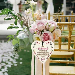 Detail of wooden heart bridesmaid gift tag with floral print on gold wedding chair