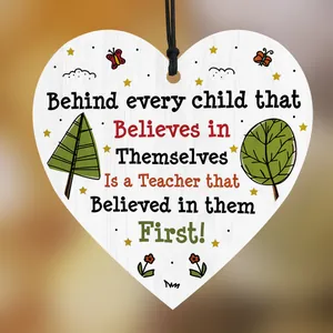Macro view of heart-shaped wooden plaque with inspirational quotes and floral art