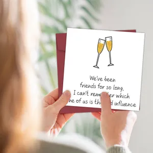 Close-up of a funny greeting card with champagne toast illustration and sentimental quote