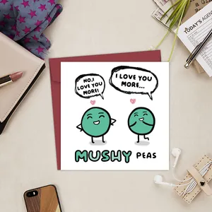 Funny mushy peas birthday card with a red envelope on a cozy lifestyle desk setting