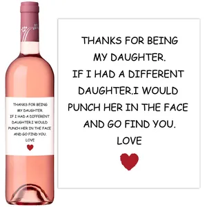 Detail of wine bottle label featuring humorous quotes and a red heart for gift decoration