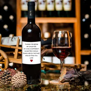 Close-up of creative minimalist wine bottle labels with humorous family greetings