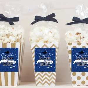 Three 2025 graduation popcorn boxes with gold stripes, dots, and black silk bows