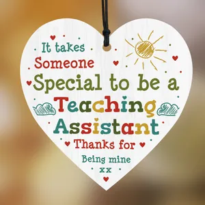 Macro shot of heart-shaped wooden plaque with teacher assistant appreciation message