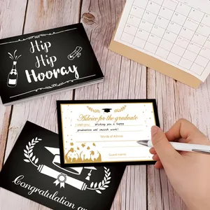 Close-up of hand writing advice for the graduate on a stylish graduation party card