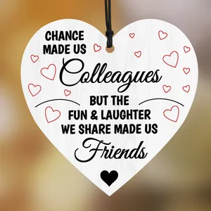Detail of wooden heart plaque with emotional quote about colleagues and friendship