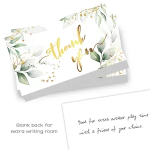Macro shot of minimalist thank you cards with green leaves and gold font on a white background