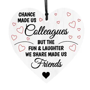 Macro detail of wooden heart plaque with friend slogan and natural grain texture