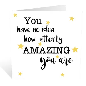 Detail of square white greeting card with bold typography and yellow star decorations