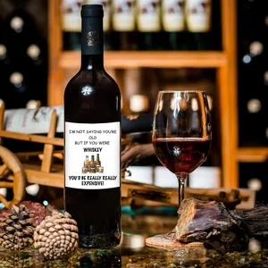 Detail of funny wine label with whiskey illustration on dark glass bottle for gift
