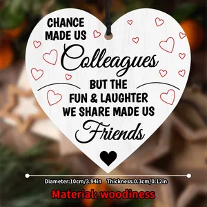 Close-up of heart-shaped wooden plaque with friendship text and red heart accents