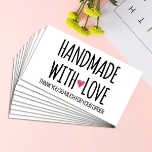 Macro shot of rectangular 'Handmade with Love' thank you cards for small business gift packaging
