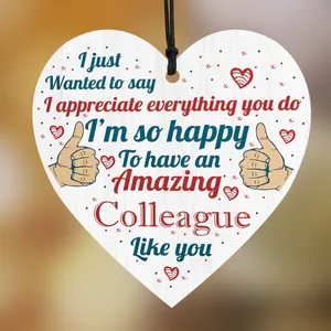 Close-up of heart-shaped wooden plaque with thank you message and black hanging rope
