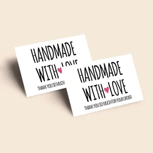 Detail of white gift cards featuring handmade with love text and pink hearts
