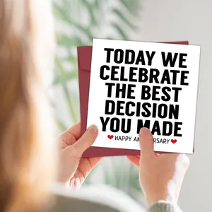 Hand holding funny square anniversary card with red envelope and heart icons