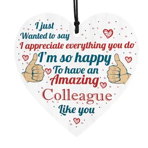 Macro view of heart-shaped wooden plaque with appreciation text and colorful floral patterns