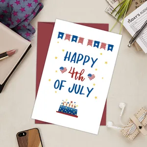 Flat lay of Happy 4th of July card with red envelope and personal office accessories